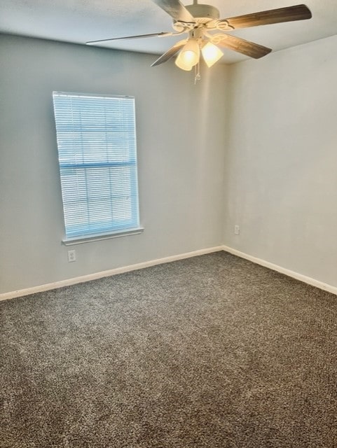 4938 Winding View Ln, Humble, TX 77346 - empty room featuring baseboards, carpet, and ceiling fan