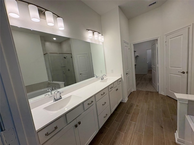 208 Cider Gum Pl, Montgomery, TX 77316 - full bathroom with a shower stall, double vanity, wood finished floors, and a closet