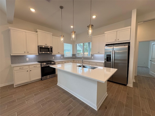 208 Cider Gum Pl, Montgomery, TX 77316 - kitchen with appliances with stainless steel finishes, a sink, dark wood finished floors, white cabinetry, and recessed lighting
