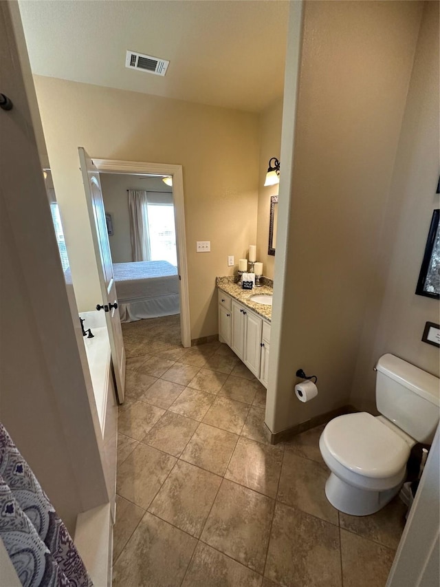 2029 Idyle Vw, Crystal Beach, TX 77650 - bathroom featuring ensuite bathroom, toilet, vanity, and tile patterned flooring