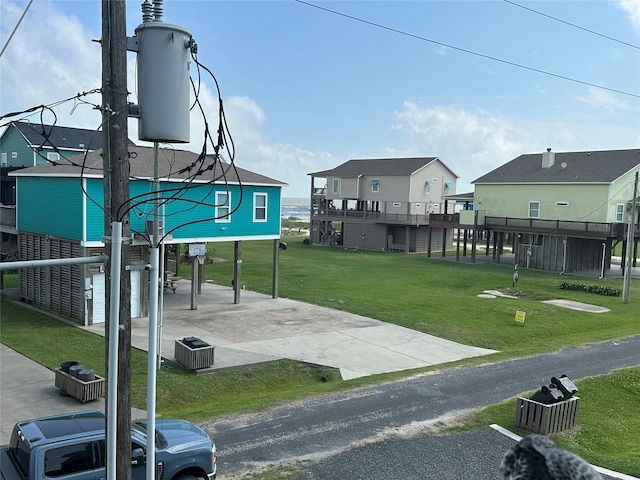 2029 Idyle Vw, Crystal Beach, TX 77650 - view of home's community with concrete driveway, a yard, and a residential view