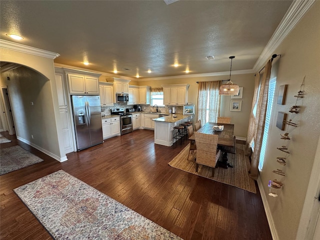 2029 Idyle Vw, Crystal Beach, TX 77650 - kitchen with appliances with stainless steel finishes, a sink, dark wood finished floors, baseboards, and crown molding