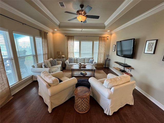 2029 Idyle Vw, Crystal Beach, TX 77650 - living room featuring plenty of natural light, a raised ceiling, dark wood-style floors, baseboards, and ornamental molding