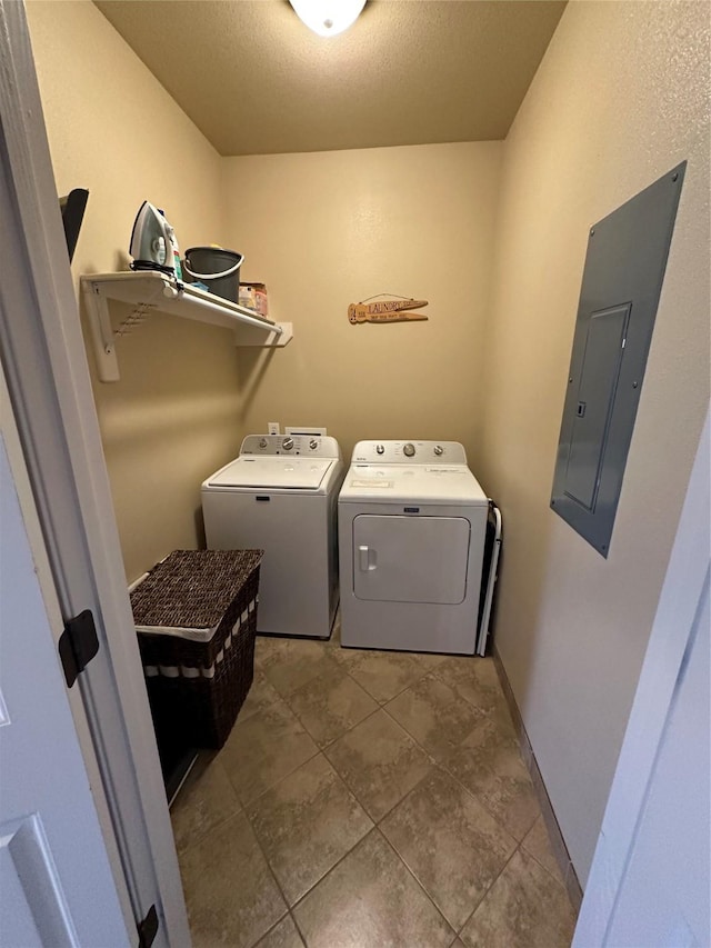 2029 Idyle Vw, Crystal Beach, TX 77650 - washroom with electric panel, washing machine and dryer, tile patterned floors, and a textured ceiling