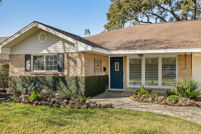 1615 Shadow Bend Dr, Houston, TX 77043 - view of front of house with a front yard, roof with shingles, brick siding, and covered porch