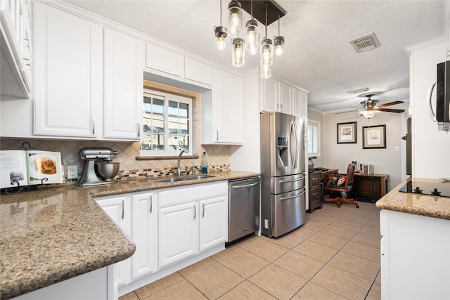 1615 Shadow Bend Dr, Houston, TX 77043 - kitchen with a sink, stainless steel appliances, white cabinetry, tasteful backsplash, and light tile patterned flooring