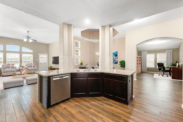 26511 Green Heron, Katy, TX 77494 - kitchen with stainless steel dishwasher, open floor plan, ceiling fan, arched walkways, and dark wood-style flooring