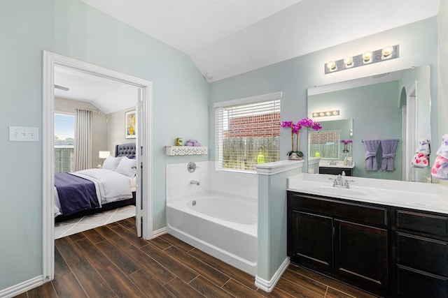 26511 Green Heron, Katy, TX 77494 - bathroom featuring lofted ceiling, a bath, connected bathroom, wood finished floors, and plenty of natural light