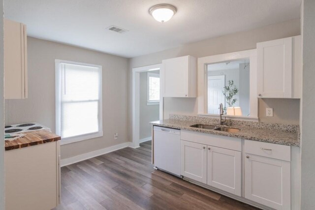 109 Porter St, La Marque, TX 77568 - kitchen featuring dishwasher, a sink, white cabinets, dark wood-type flooring, and baseboards