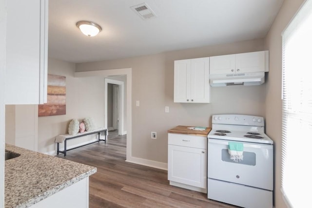 109 Porter St, La Marque, TX 77568 - kitchen with white range with electric stovetop, under cabinet range hood, white cabinetry, dark wood finished floors, and baseboards