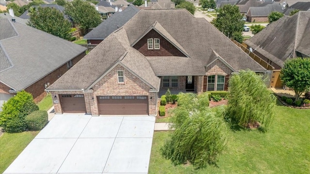 3490 Prescott Dr, Beaumont, TX 77706 - view of front of home featuring brick siding, roof with shingles, a garage, concrete driveway, and a front lawn