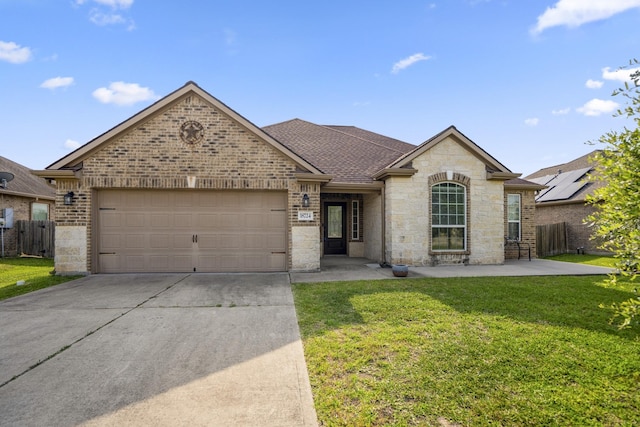 18724 Carrizo Trl, Magnolia, TX 77355 - french country style house featuring driveway, a garage, stone siding, a shingled roof, and brick siding