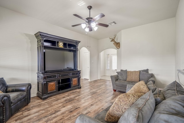 18724 Carrizo Trl, Magnolia, TX 77355 - living room with arched walkways, ceiling fan, wood finished floors, and baseboards