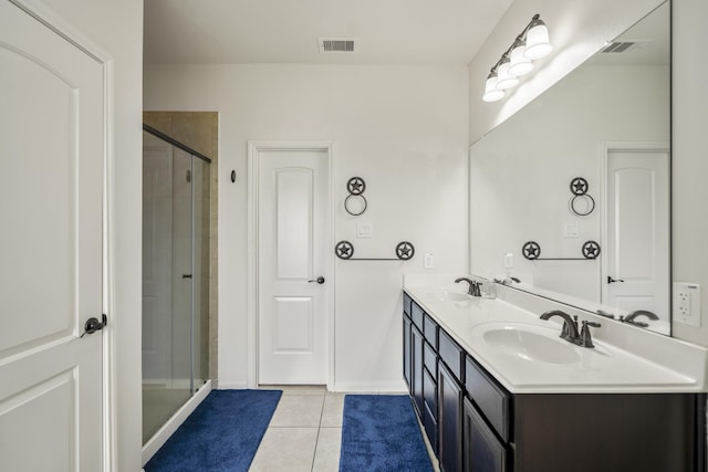 18724 Carrizo Trl, Magnolia, TX 77355 - bathroom with tile patterned floors, a stall shower, double vanity, and baseboards