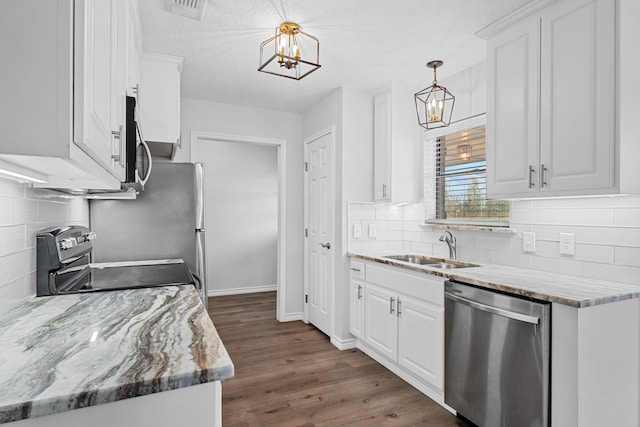 3009 Fm 50, Brenham, TX 77833 - kitchen with appliances with stainless steel finishes, a chandelier, a sink, and white cabinets