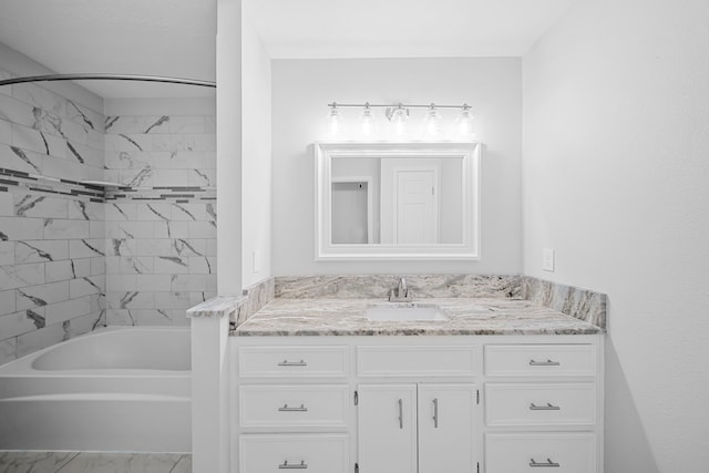 3009 Fm 50, Brenham, TX 77833 - bathroom with vanity, marble look tiles, and tub / shower combination