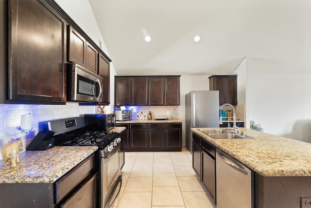 2910 High Garden Ln, Fresno, TX 77545 - kitchen featuring stainless steel appliances, a sink, backsplash, dark brown cabinetry, and lofted ceiling