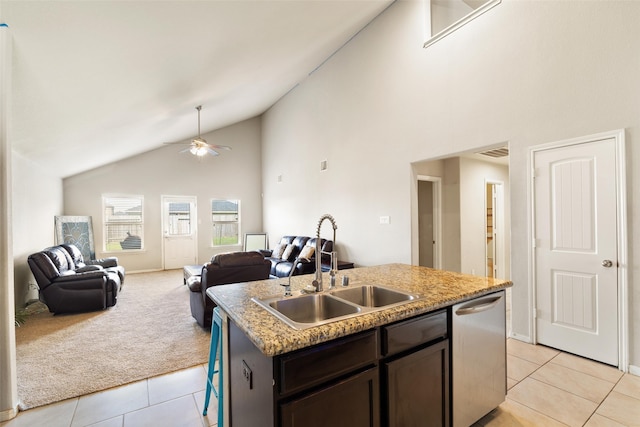 2910 High Garden Ln, Fresno, TX 77545 - kitchen featuring stainless steel dishwasher, a sink, light tile patterned flooring, open floor plan, and high vaulted ceiling