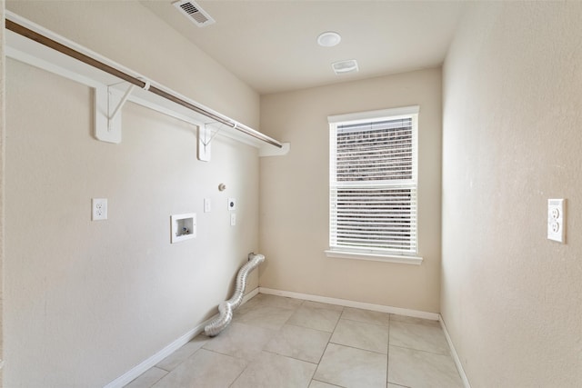 2910 High Garden Ln, Fresno, TX 77545 - laundry room with hookup for an electric dryer, washer hookup, hookup for a gas dryer, light tile patterned floors, and baseboards