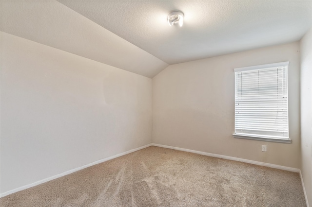 2910 High Garden Ln, Fresno, TX 77545 - empty room with carpet floors, vaulted ceiling, baseboards, and a textured ceiling