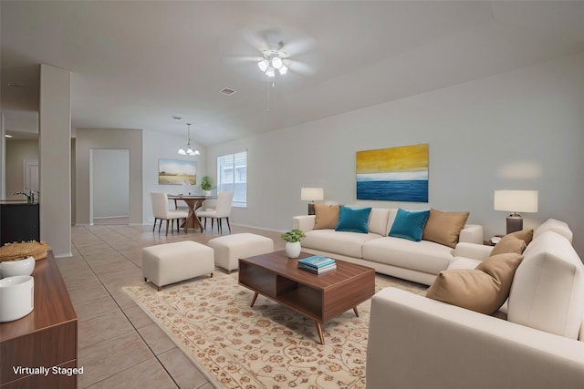24511 Carlton Springs Ln, Katy, TX 77494 - living room featuring a ceiling fan, light tile patterned floors, a chandelier, vaulted ceiling, and baseboards