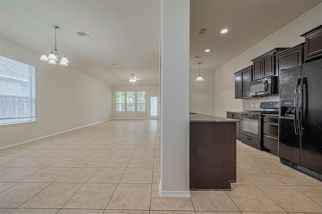 24511 Carlton Springs Ln, Katy, TX 77494 - kitchen with black appliances, light tile patterned flooring, a chandelier, backsplash, and hanging light fixtures