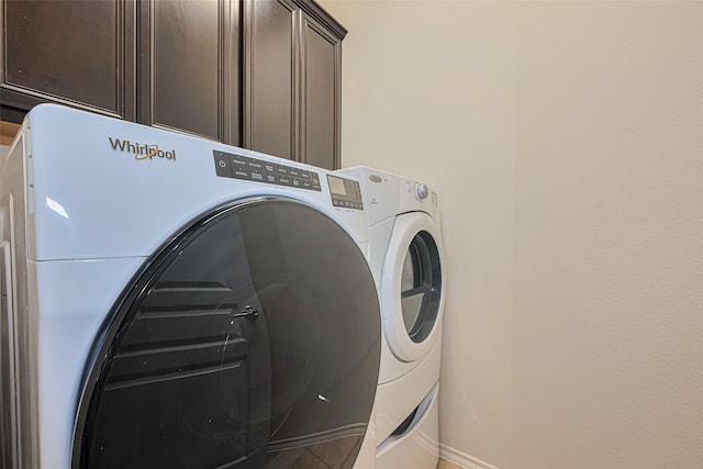24511 Carlton Springs Ln, Katy, TX 77494 - laundry room featuring independent washer and dryer, cabinet space, baseboards, and tile patterned flooring