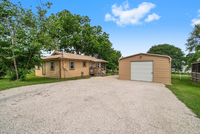 21 Clearview St, Point Blank, TX 77364 - view of front of property with driveway, an outbuilding, a garage, and a front lawn