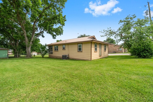 21 Clearview St, Point Blank, TX 77364 - rear view of property featuring a lawn and central AC unit