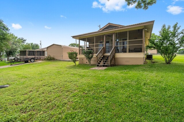 21 Clearview St, Point Blank, TX 77364 - back of house with a sunroom, a yard, and cooling unit