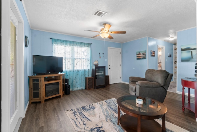 21 Clearview St, Point Blank, TX 77364 - living room featuring a textured ceiling, wood finished floors, ceiling fan, crown molding, and baseboards