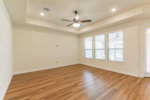 5746 Bobwhite Trl, Manvel, TX 77578 - spare room with a tray ceiling, baseboards, ceiling fan, light wood-style flooring, and recessed lighting