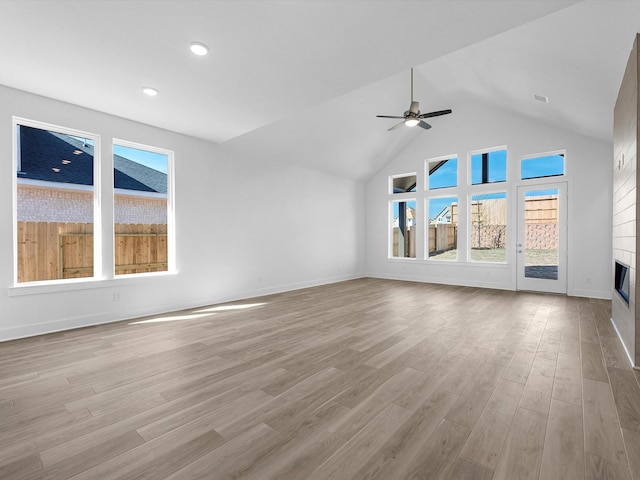 14674 Hereford Grove Ln, Montgomery, TX 77316 - unfurnished living room featuring a ceiling fan, a glass covered fireplace, wood finished floors, lofted ceiling, and recessed lighting