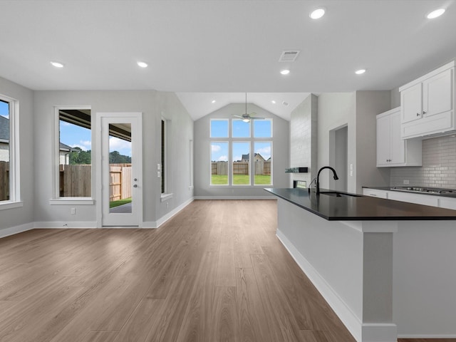 14690 Hereford Grove Ln, Montgomery, TX 77316 - kitchen with open floor plan, dark countertops, light wood finished floors, a sink, and lofted ceiling
