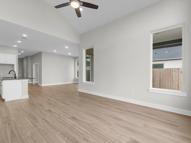 14690 Hereford Grove Ln, Montgomery, TX 77316 - unfurnished living room featuring ceiling fan, light wood-style floors, baseboards, a sink, and recessed lighting