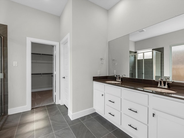 14690 Hereford Grove Ln, Montgomery, TX 77316 - full bath featuring a shower stall, double vanity, a walk in closet, and baseboards