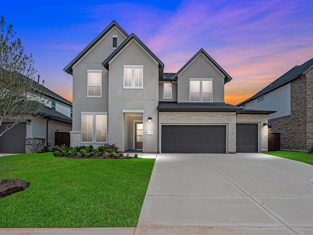14690 Hereford Grove Ln, Montgomery, TX 77316 - view of front of home with stucco siding, stone siding, a front yard, driveway, and a garage