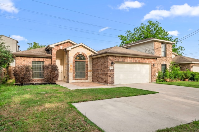 5106 Hardy St, Houston, TX 77009 - traditional-style house with brick siding, a garage, a front yard, and driveway