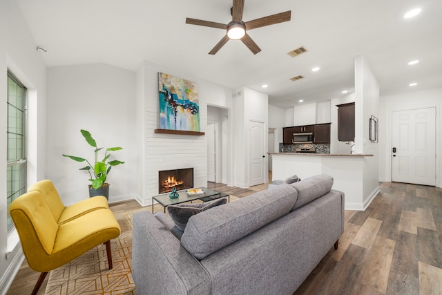5106 Hardy St, Houston, TX 77009 - living room featuring ceiling fan, a large fireplace, baseboards, wood finished floors, and recessed lighting
