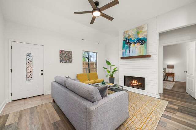 5106 Hardy St, Houston, TX 77009 - living area featuring wood finished floors, a ceiling fan, a fireplace, lofted ceiling, and baseboards