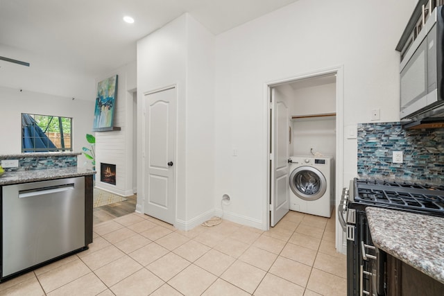 5106 Hardy St, Houston, TX 77009 - kitchen featuring washer / clothes dryer, stainless steel appliances, tasteful backsplash, light tile patterned floors, and recessed lighting