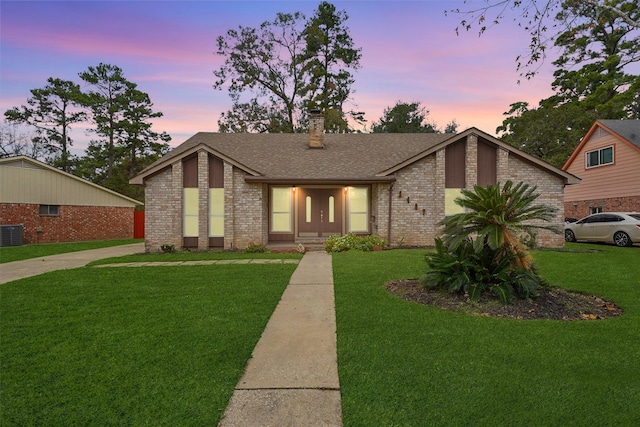 2407 Rambling Brook Dr, Spring, TX 77373 - mid-century home featuring brick siding, a front lawn, a chimney, and roof with shingles
