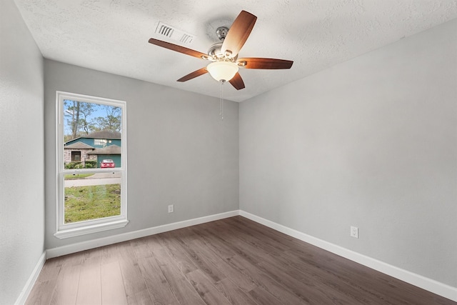 2407 Rambling Brook Dr, Spring, TX 77373 - spare room featuring wood finished floors, baseboards, ceiling fan, and a textured ceiling