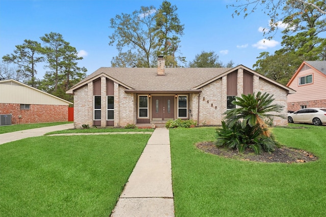 2407 Rambling Brook Dr, Spring, TX 77373 - mid-century inspired home with a chimney, brick siding, a shingled roof, and a front yard