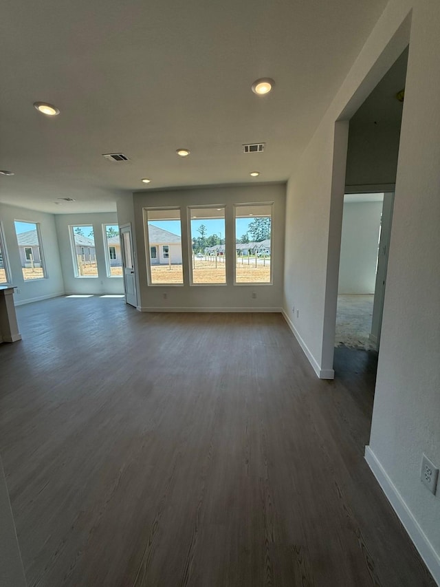 10300 Woodhill Spa Ln, Cleveland, TX 77327 - unfurnished living room with dark wood-style floors, baseboards, and recessed lighting