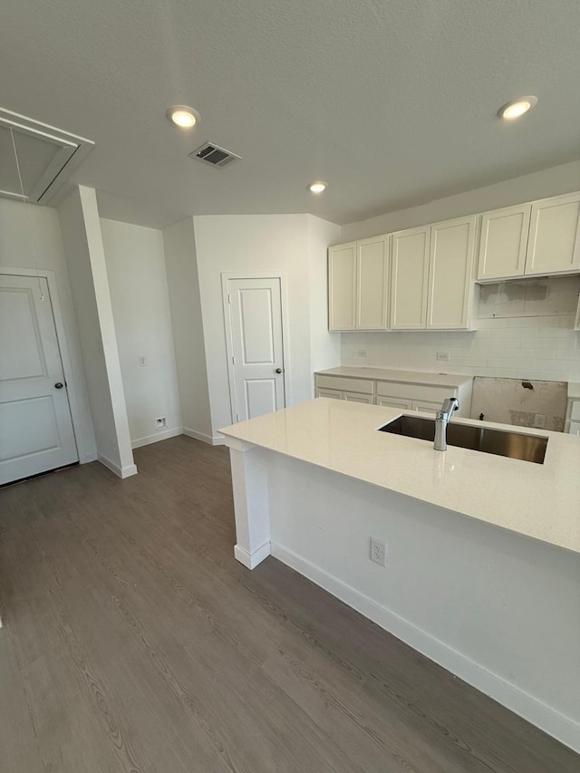 10300 Woodhill Spa Ln, Cleveland, TX 77327 - kitchen featuring a sink, dark wood-type flooring, baseboards, white cabinetry, and recessed lighting