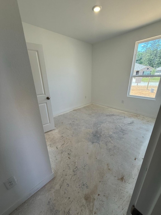 10300 Woodhill Spa Ln, Cleveland, TX 77327 - spare room featuring concrete floors and baseboards