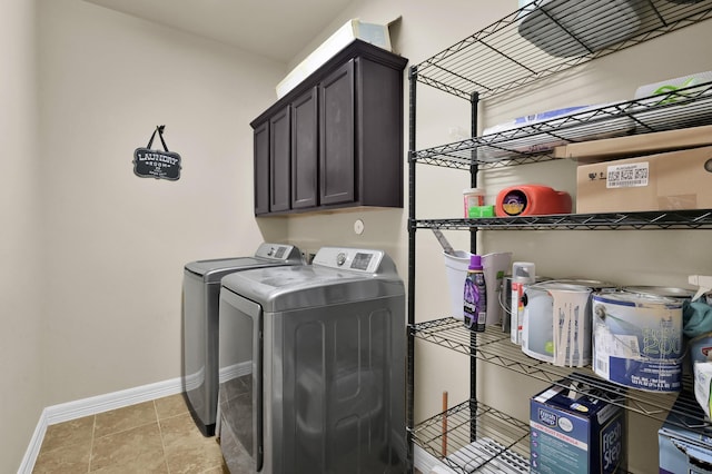 999 Arbor Xing, Conroe, TX 77303 - laundry room with washing machine and clothes dryer, baseboards, cabinet space, and light tile patterned floors