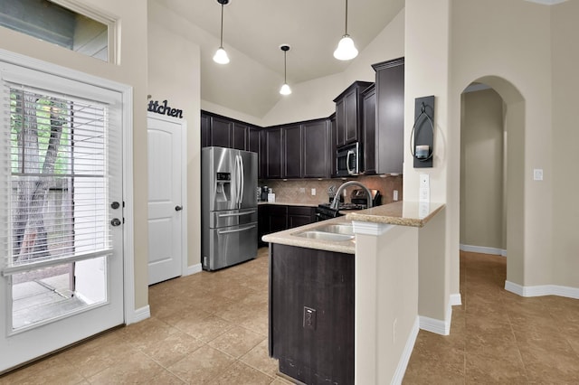999 Arbor Xing, Conroe, TX 77303 - kitchen with appliances with stainless steel finishes, backsplash, light tile patterned floors, arched walkways, and high vaulted ceiling