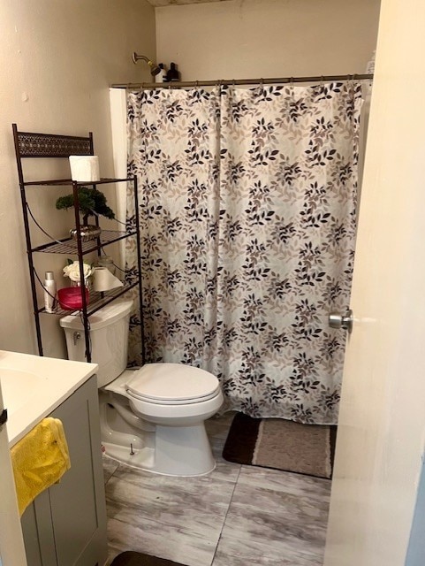 17102 Dewgrass Dr, Houston, TX 77060 - bathroom featuring toilet, vanity, and curtained shower